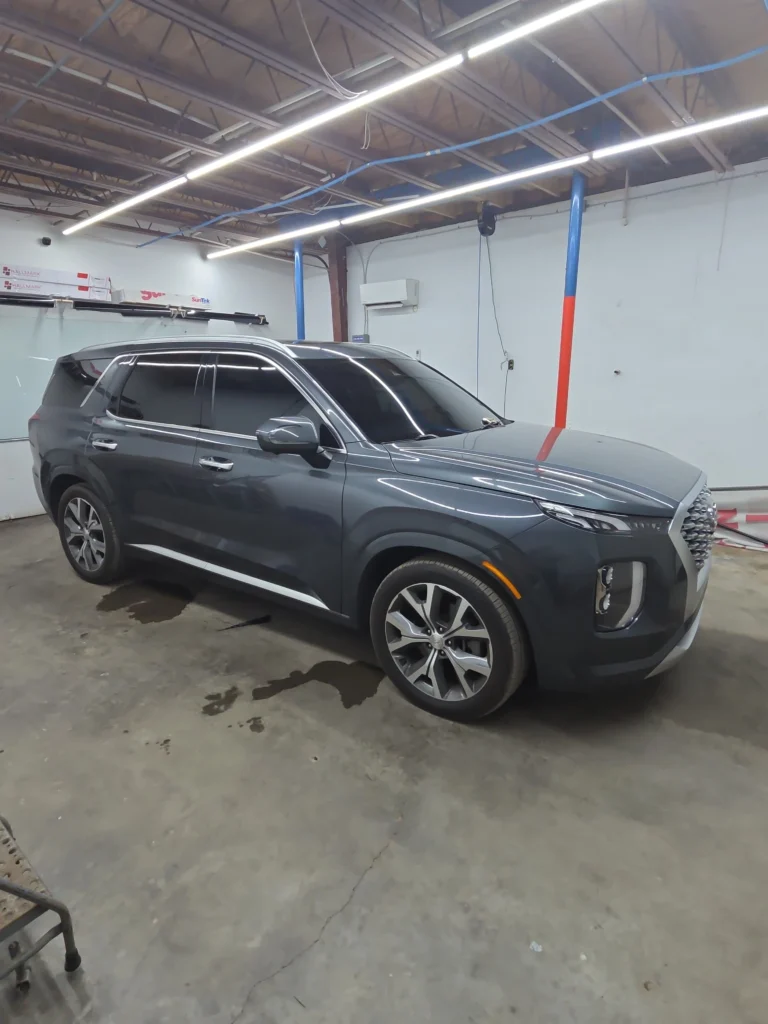 professional window tinting service being applied to vehicle windows enhancing privacy and reducing heat auto window tinting