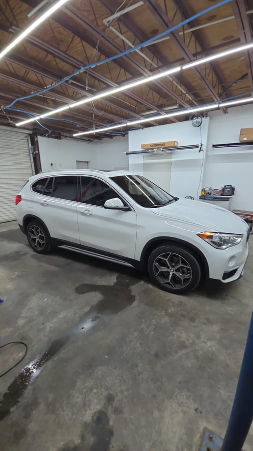 Window tinting installation on BMW X1 SUV